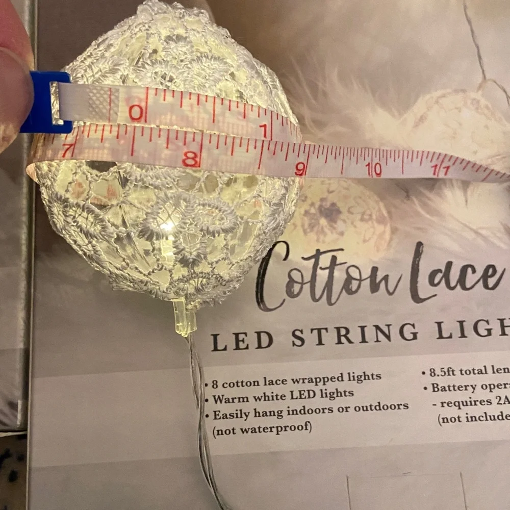 Mercury Innovations Cotton Clear Globe LED String Lights wrapped in white lace.